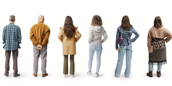 Eight people standing in a row, facing away from the camera against a white background.