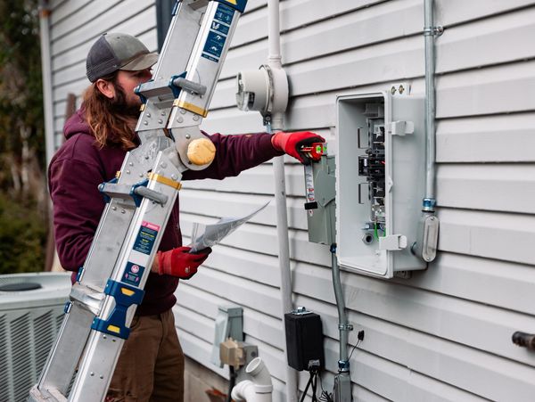 Electrician working on outdoor panel