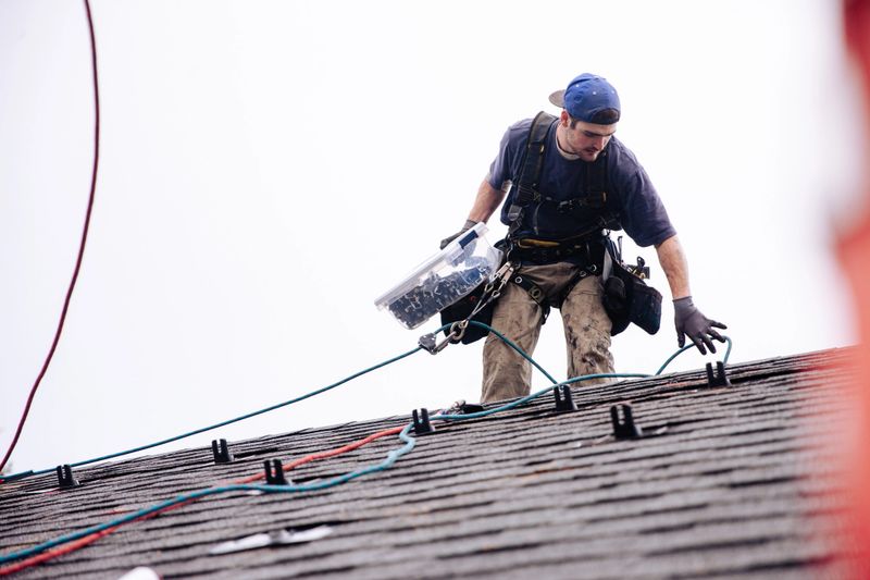 Professional engineer installing solar panels on roof of a residential home in Portland, Oregon, Pacific Northwest USA. Green energy concepts.