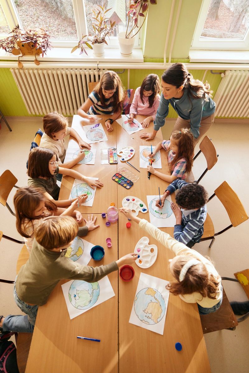 High angle view of elementary teacher having an art class with group of her students in the classroom.
