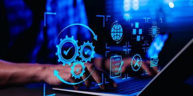 Hands typing on a laptop with digital automation icons overlay.