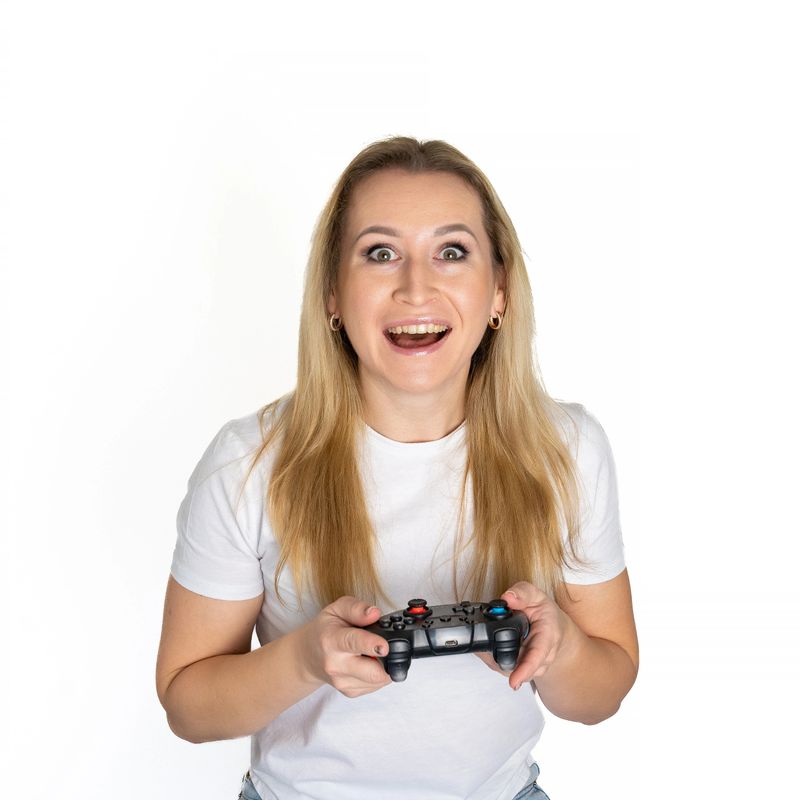 Photo of happy excited crazy smiling woman playing videogames addicted to playstation isolated on white background