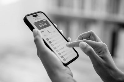 Person using a mobile banking app on a smartphone.