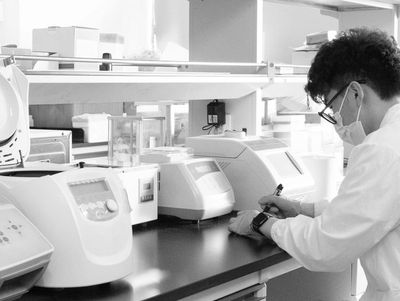 Scientist working in a lab with equipment.