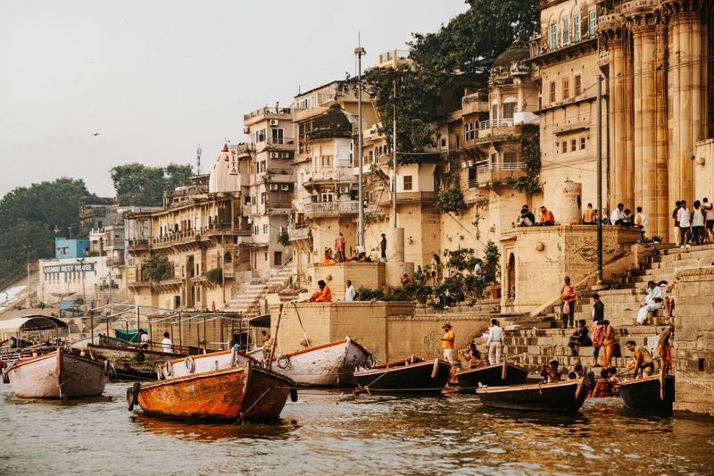 Colourful scene showing boats on the sacred Ganges River at Dashashwamedh Ghat in the holy city of Varanasi, Uttar Pradesh, India.
