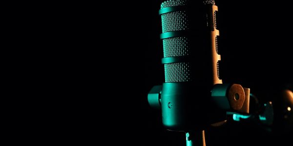 A close-up of a microphone under dramatic lighting.