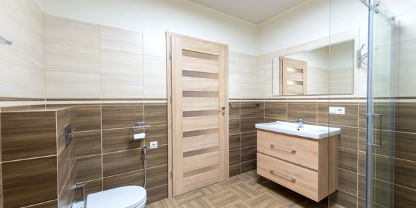 Bespoke bathroom fully tiled with vanity units and wet room