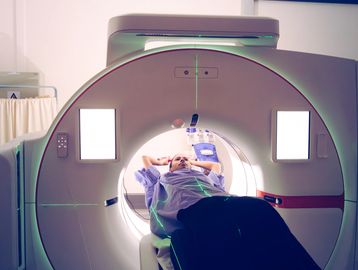 Patient undergoing a CT scan inside a modern medical imaging machine.