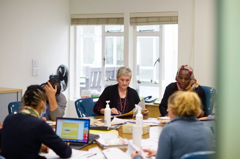 Professionals gather around a table discussing business growth strategies.