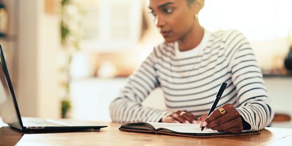 A person writing something down