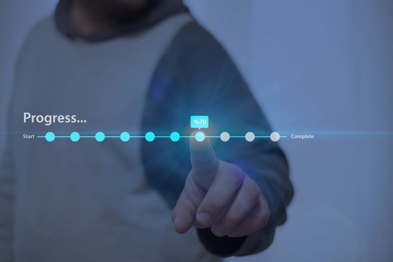 Person interacting with a futuristic progress bar, symbolizing goal achievement, project development, performance monitoring, and task completion.