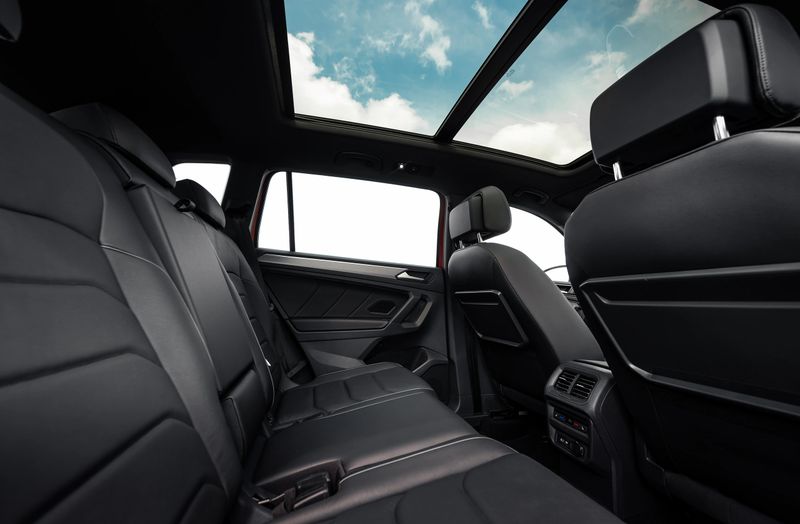 SUV or wagon interior with black leather seats and panoramic roof.