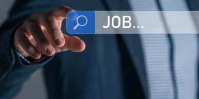 Person in business attire searching for jobs online.
