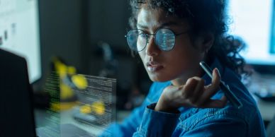 Woman analyzing data on a transparent screen.