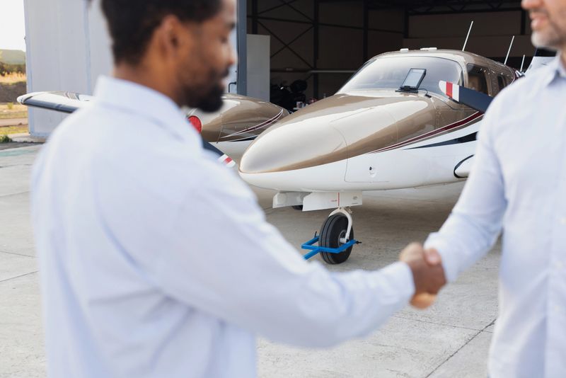 Businessman shaking hands with an agent after making a deal of buying a private jet