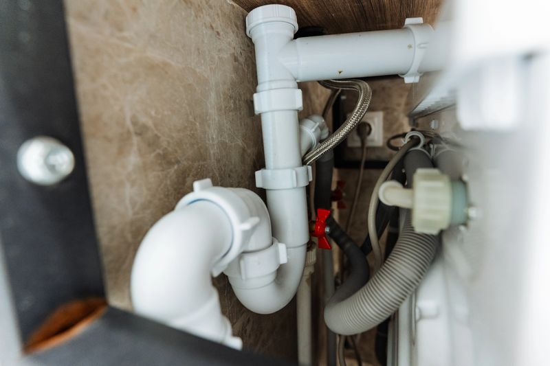 This image provides a detailed and highly informative closeup view of a bathroom sink pipe, showcasing its intricate structure and crucial role within the plumbing system of any modern home
