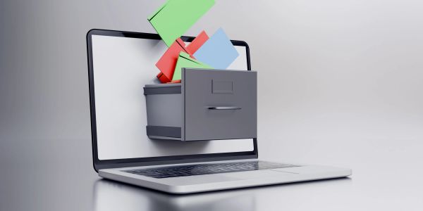 A digital filing cabinet drawer with colorful folders emerging from a laptop screen.