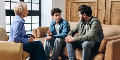 Three people engaged in a serious conversation.