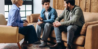 Couple attending therapy session with therapist.