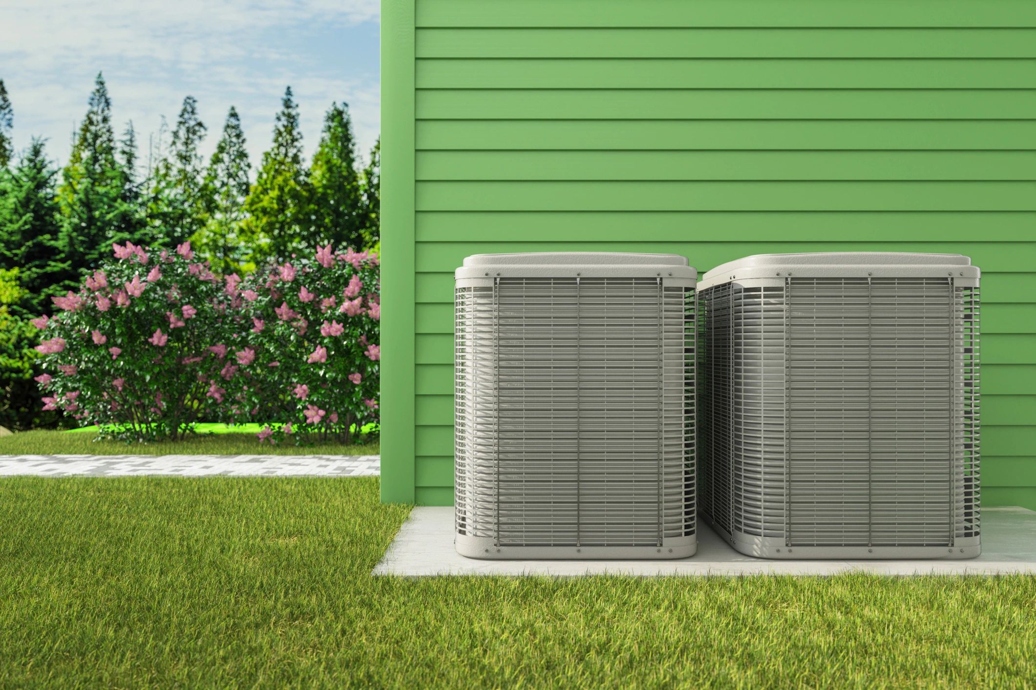 Two outdoor units (condensers) outside a green home 