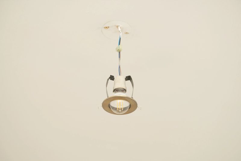 A sleek recessed light fixture hangs from the ceiling, showcasing its clean design and bright illumination. This modern lighting element adds style to any indoor space.