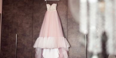 Elegant pink and white dress hanging.