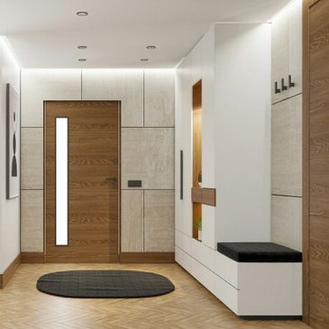Modern entryway with wood door, white cabinetry, and black rug.