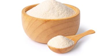 Amino acid feed supplement powder in a wooden bowl.