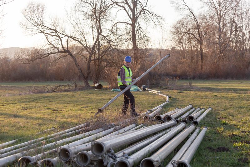 Installing irrigation pipeline for watering land