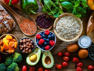 A colorful assortment of healthy foods including fruits, vegetables, nuts, and grains.