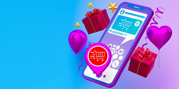 A smartphone with shopping icons, gift boxes, and festive balloons, symbolizing online shopping.