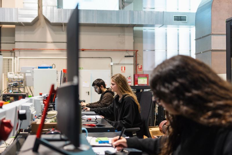 Group of engineering students concentrating on their computer work in a university laboratory