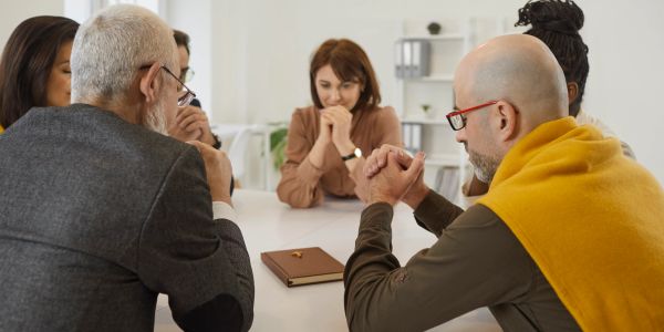 People praying together in a group.