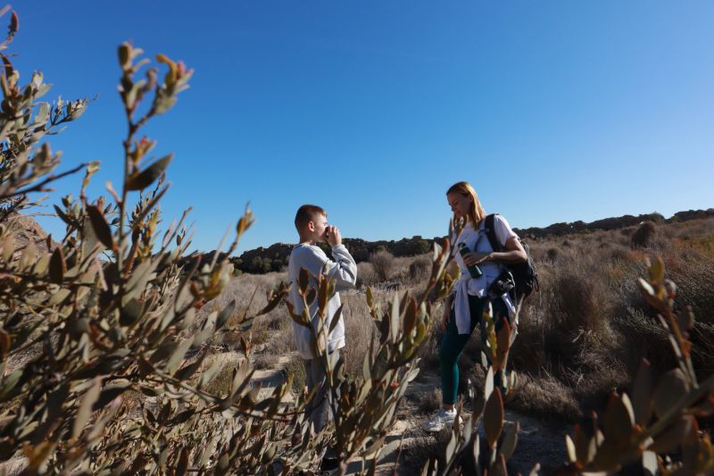 Happy family hiking together and enjoy view in autumn mountains.