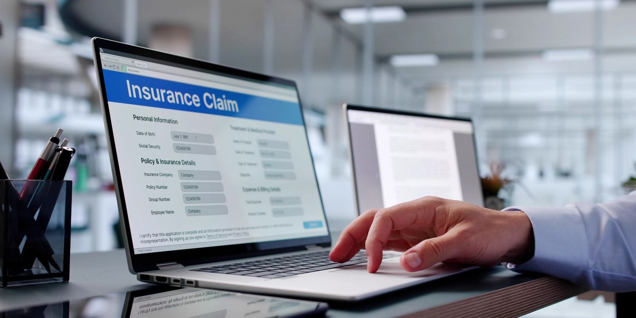 Man filling out online insurance forms for weight loss medication using a laptop.