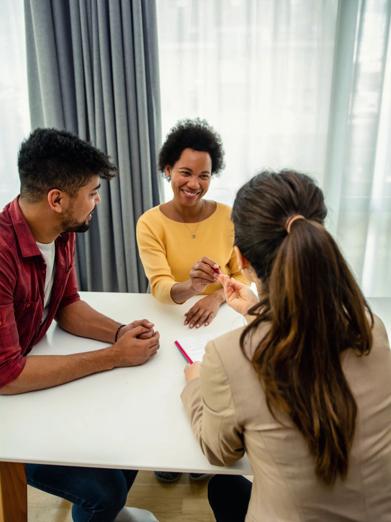 The black couple is in a meeting with their financial advisor.