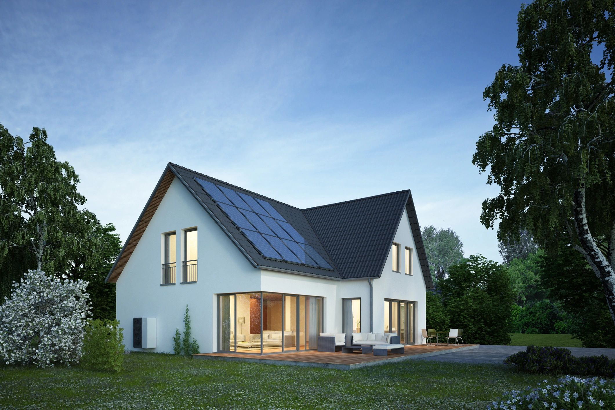 Modern white house with solar panels and outdoor seating on a wooden deck.