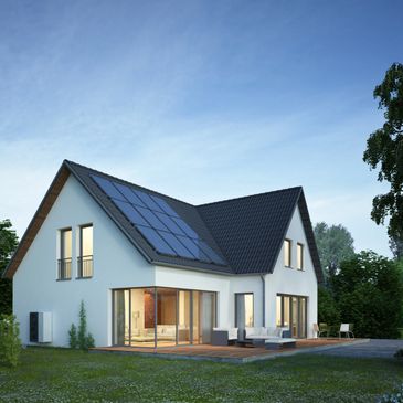 Modern house with solar panels on the roof at dusk.