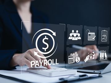 Businesswoman managing payroll and financial tasks using digital interface.
