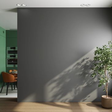 Modern interior with a gray wall, wooden floor, and a potted plant.