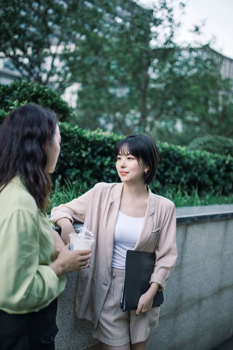 Two female businessmen are communicating with coffee and documents in the commercial office building park