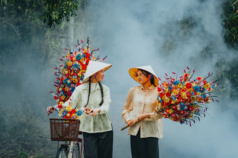 People selling flowers made of colored paper in the Thanh Tien traditional village, Hue city, Vietnam during Vietnam's traditional Tet holiday. Travel and people concept