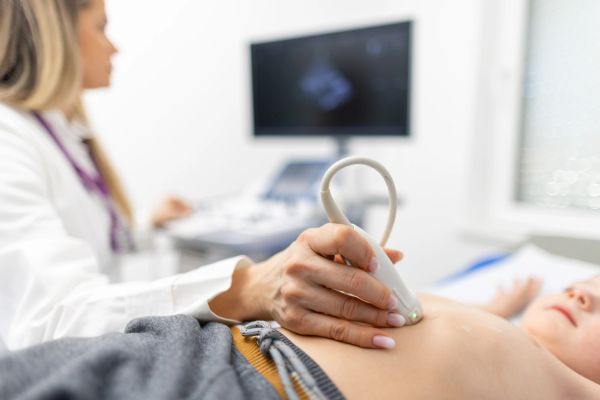 Doctor performing an ultrasound on a child.