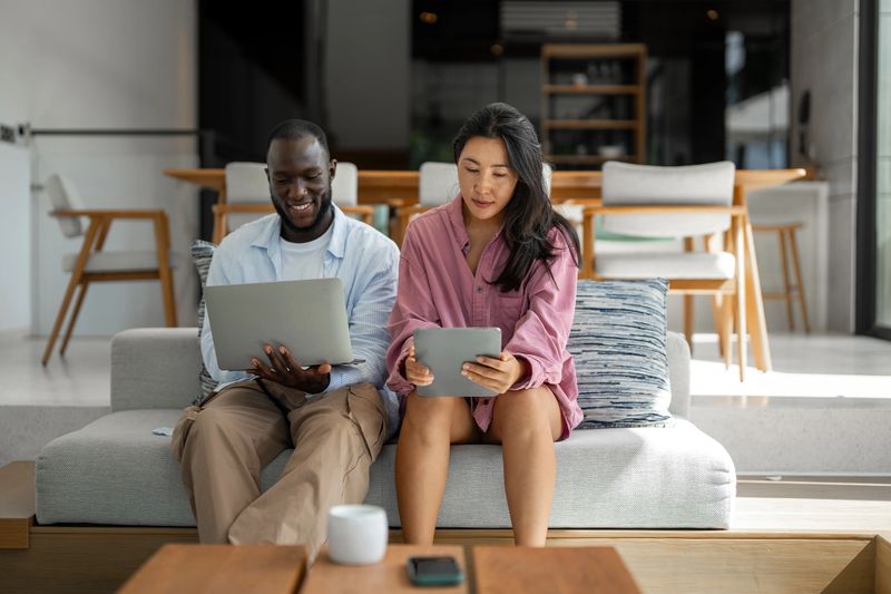 Online entertainment and social media. Diverse, multiethnic couple enjoying the digital world, staying connected, and exploring the possibilities of the internet