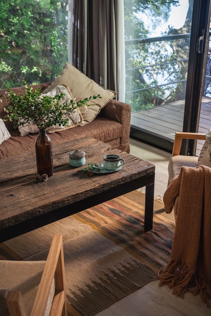 Rustic living room, with wooden decoration, earth colors, blankets, cup of coffee.