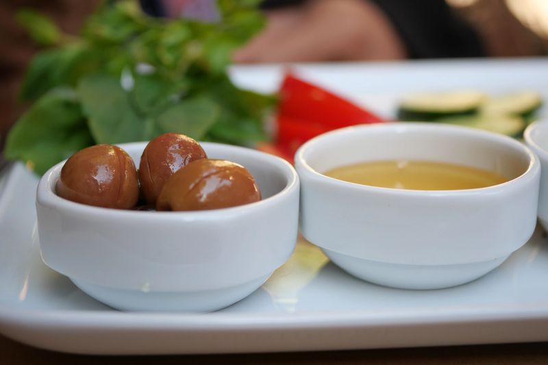 A vibrant array of colorful appetizers with delectable dips and fresh, aromatic herbs