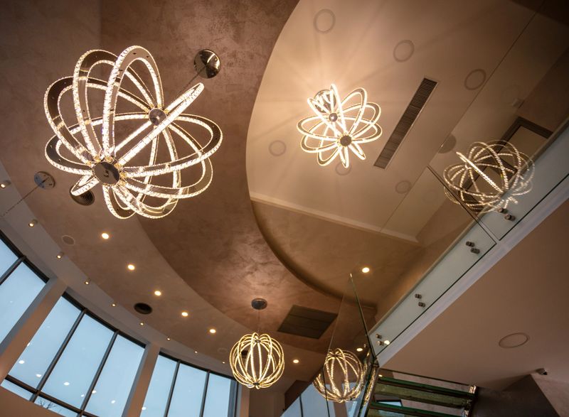 Contemporary illumination, featuring intricate chandelier designs in an upscale indoor environment, creating an atmosphere of sophistication and modern aesthetics while showcasing architectural and decorative lighting excellence