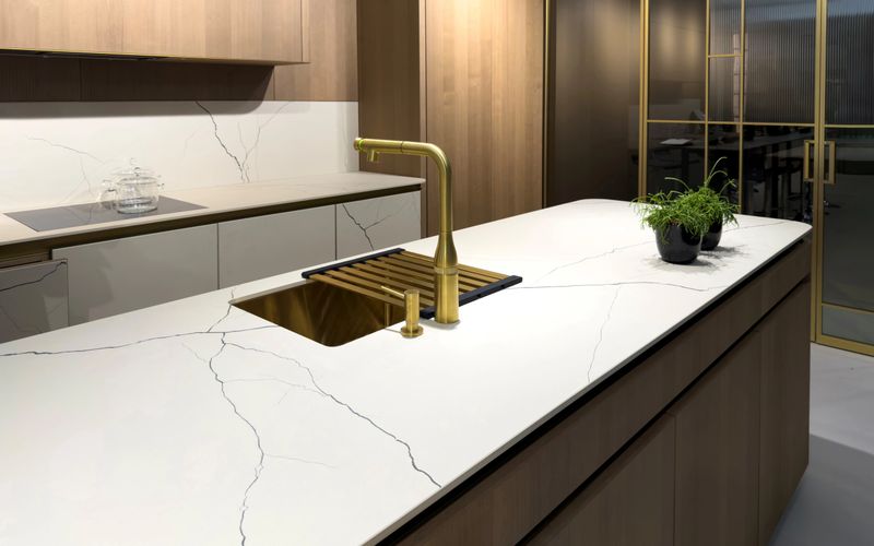 Modern kitchen interior with gold faucet sink and marble countertop