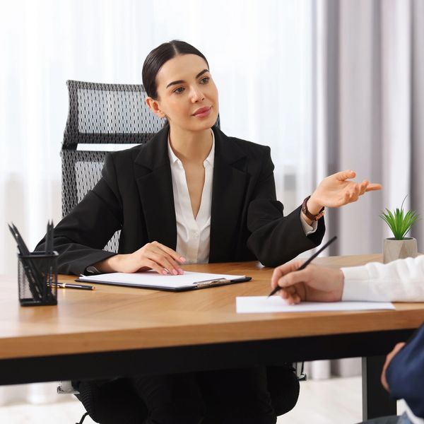 Businesswoman interviewing a candidate at the desk.