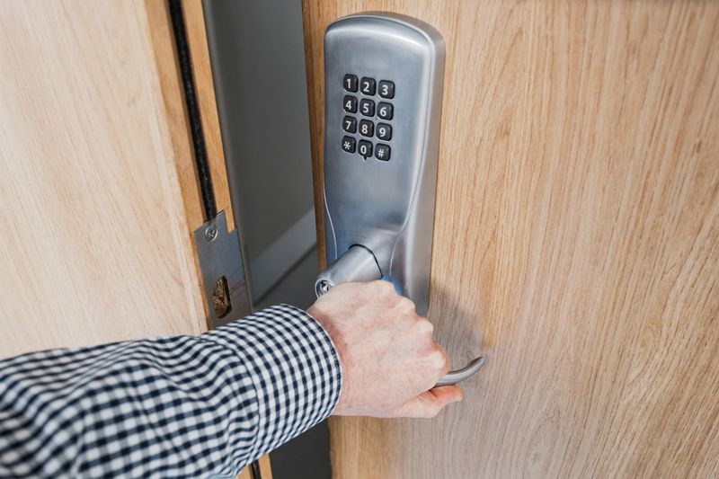 Hospital worker seen having used a keypad access to access a clinical room within a typical NHS hospital in the UK. The door leads to a diabetic clinic.